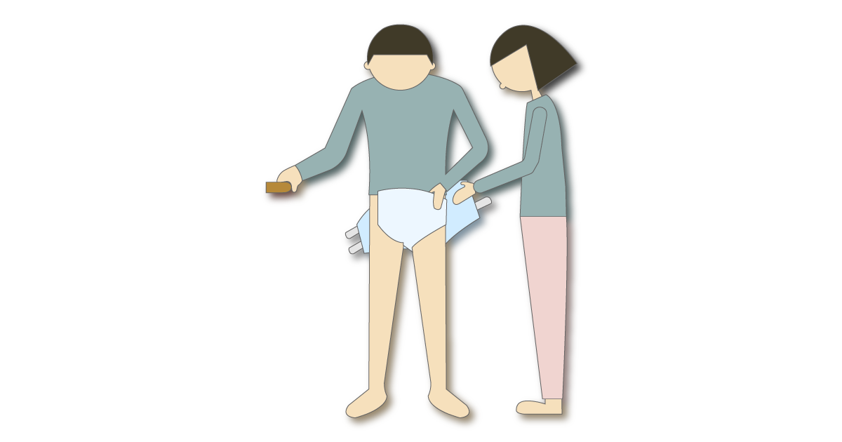介助者がテープ型紙おむつの着脱を手伝う様子